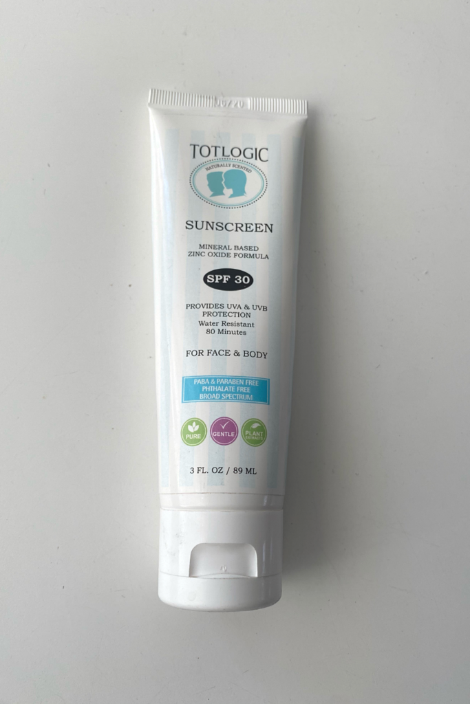 A white bottle reads says, "Totlogic." It is a picture of SPF 30 sunscreen for face and body that is mineral based, provides UVA & UVB protection, and is water resistant for 80 minutes. It is PABA and paraben free, phthalate free and broad spectrum. 