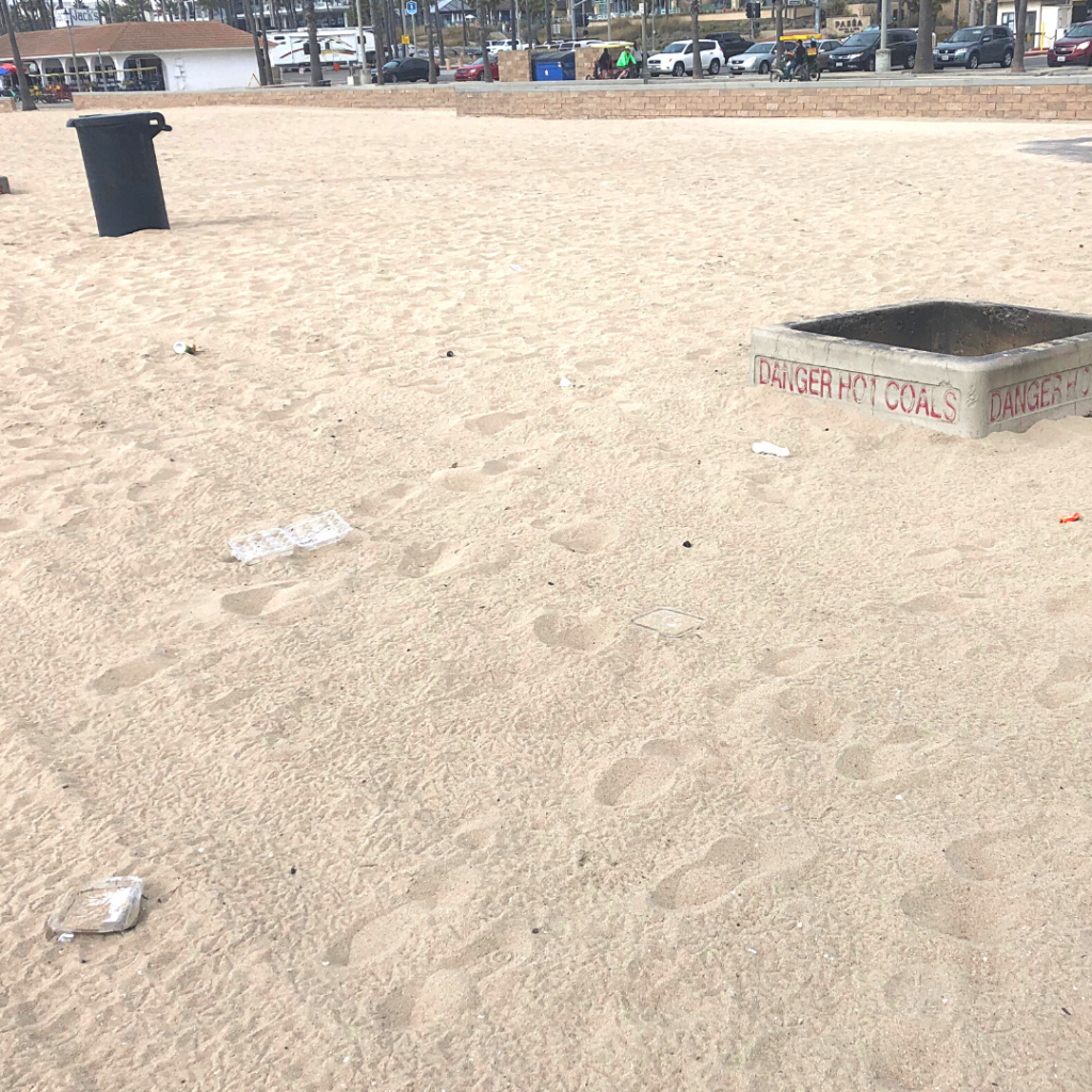 Image of trash littering the beach, showing the need for a beach clean up